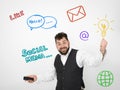 Young man with black beard is posing and looking at his smartphone in front of white background with different emotions Royalty Free Stock Photo