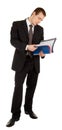 Young man in a black business suit with a folder i Royalty Free Stock Photo