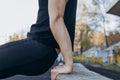 A young man in black clothes is exercising outdoors close up. fitness athlete on the sports field. training with projectiles. warm Royalty Free Stock Photo