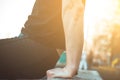 A young man in black clothes is exercising outdoors close up. fitness athlete on the sports field. training with projectiles. warm Royalty Free Stock Photo