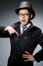 Young man in black coat and hat against gray Royalty Free Stock Photo