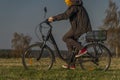 Young man on black electric bike in spring color evening