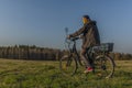 Young man on black electric bike in spring color evening Royalty Free Stock Photo