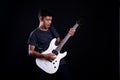 Young man in black leather jacket with electric guitar in studio Royalty Free Stock Photo