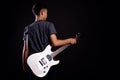 Young man in black leather jacket with electric guitar in studio Royalty Free Stock Photo