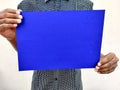 Young man in black shirt holding a blank blue color chart Royalty Free Stock Photo