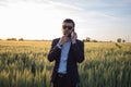 Portrait of stylish male with cellphone summer wheat field Royalty Free Stock Photo