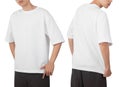 Young man in blank oversize t-shirt mockup front and back used as design template, isolated on white background Royalty Free Stock Photo