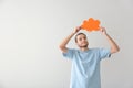 Young man with blank speech bubble on light background Royalty Free Stock Photo