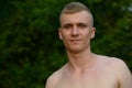 Young man with blond hair shirtless at the park outdoors Royalty Free Stock Photo