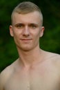 Young man with blond hair shirtless at the park outdoors Royalty Free Stock Photo