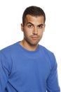 Young man in blouse with skeptical look on white Royalty Free Stock Photo