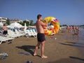 The young man blows his ring on the beach