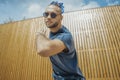 Young man with blue dreadlocks dancing reggaeton in the street. Royalty Free Stock Photo