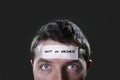 Young man with blue eyes and tape text out of order on forehead in dry empty mind Royalty Free Stock Photo