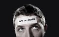 Young man with blue eyes and tape text out of order on forehead in dry empty mind Royalty Free Stock Photo