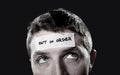 Young man with blue eyes and tape text out of order on forehead in dry empty mind