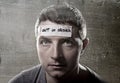Young man with blue eyes and tape text out of order on forehead in dry empty mind Royalty Free Stock Photo