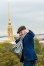 Young man in a blue jacket, scarf and cap shows a gesture of punch Royalty Free Stock Photo