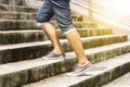 Young man in blue jeans and sneaker shoes walking up stairs outd Royalty Free Stock Photo