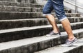 Young man in blue jeans and sneaker shoes walking up stairs outd Royalty Free Stock Photo