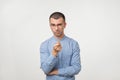 Young man in blue shirt have an idea. He is pointing with pencil on camera. Royalty Free Stock Photo