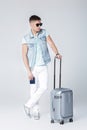 Young man in blue shirt with suitcase