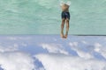 Young man in blue shorts swimming in the ocean under the blue sky Royalty Free Stock Photo