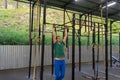 A young man in blue sports pants and a green T-shirt performs ex Royalty Free Stock Photo