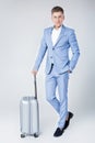 Young man in blue suit with suitcase Royalty Free Stock Photo