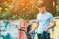 A young man with a BMX bike stands on the graffiti wall background. Portrait of BMX rider. Street culture. Sunshine Royalty Free Stock Photo