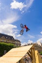 Young man on bmx doing tricks, during a Freestyle bmx demonstration in Paris. Royalty Free Stock Photo