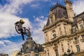 Young man on bmx doing tricks, during a Freestyle bmx demonstration in Paris. Royalty Free Stock Photo