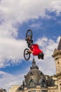 Young man on bmx doing tricks, during a Freestyle bmx demonstration in Paris. Royalty Free Stock Photo