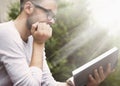 Young man with book of knowledge. Handsome male student with beard reading book. (Knowledge, education, development concept) Royalty Free Stock Photo