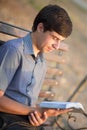 Young man with a book in the park Royalty Free Stock Photo