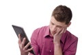 Young man bored holding a tablet. Royalty Free Stock Photo