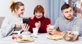 Man bored while wife and mother looking at phones Royalty Free Stock Photo