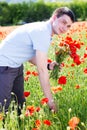 Young man with bouquet of poppies Royalty Free Stock Photo