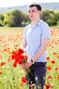 Young man with bouquet of poppies Royalty Free Stock Photo