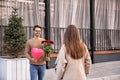 Young man with bouquet of roses and balloon waiting for his girlfriend outdoors Royalty Free Stock Photo