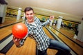 Young man at the bowling alley with the ball. Royalty Free Stock Photo