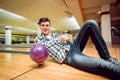 Young man at the bowling alley with the ball. Royalty Free Stock Photo