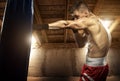 Young man boxing, exercise in the attic Royalty Free Stock Photo