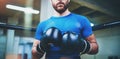Young man in boxing gloves. Young Boxer fighter over blurred background.Boxing man ready to fight. Boxing, workout Royalty Free Stock Photo