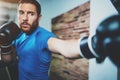 Young man boxing workout in fitness gym on blurred background.Athletic man training hard.Kick boxing concept.Horizontal. Royalty Free Stock Photo