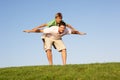 Young man with boy playing in a field Royalty Free Stock Photo