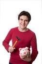 Young man break the piggy bank Royalty Free Stock Photo