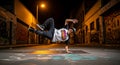Young Man Breakdancing in Urban Street Setting at Night Royalty Free Stock Photo
