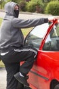 Young Man Breaking Into Car